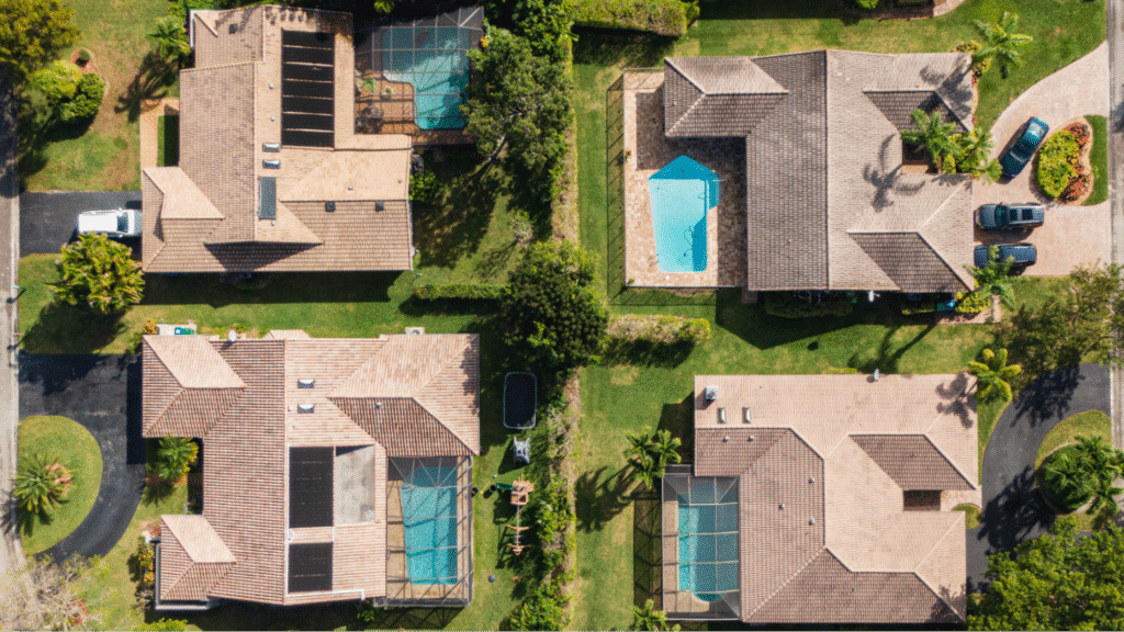 Top-down view of residential houses with brown tile roofs in a Tampa, Florida