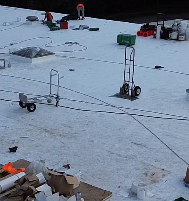 Commercial flat roof installation with TPO/PVC membrane.