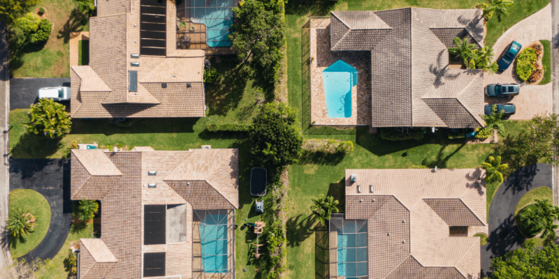 Top-down view of residential houses with brown tile roofs in a Tampa, Florida