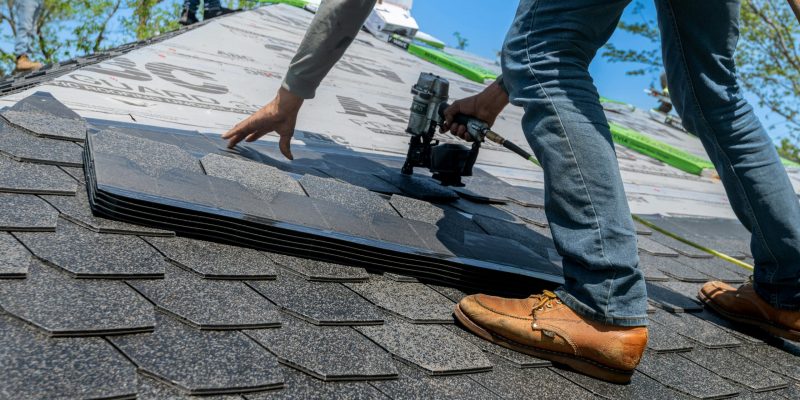 A roofing contractor repairing a leak on a Tampa home.